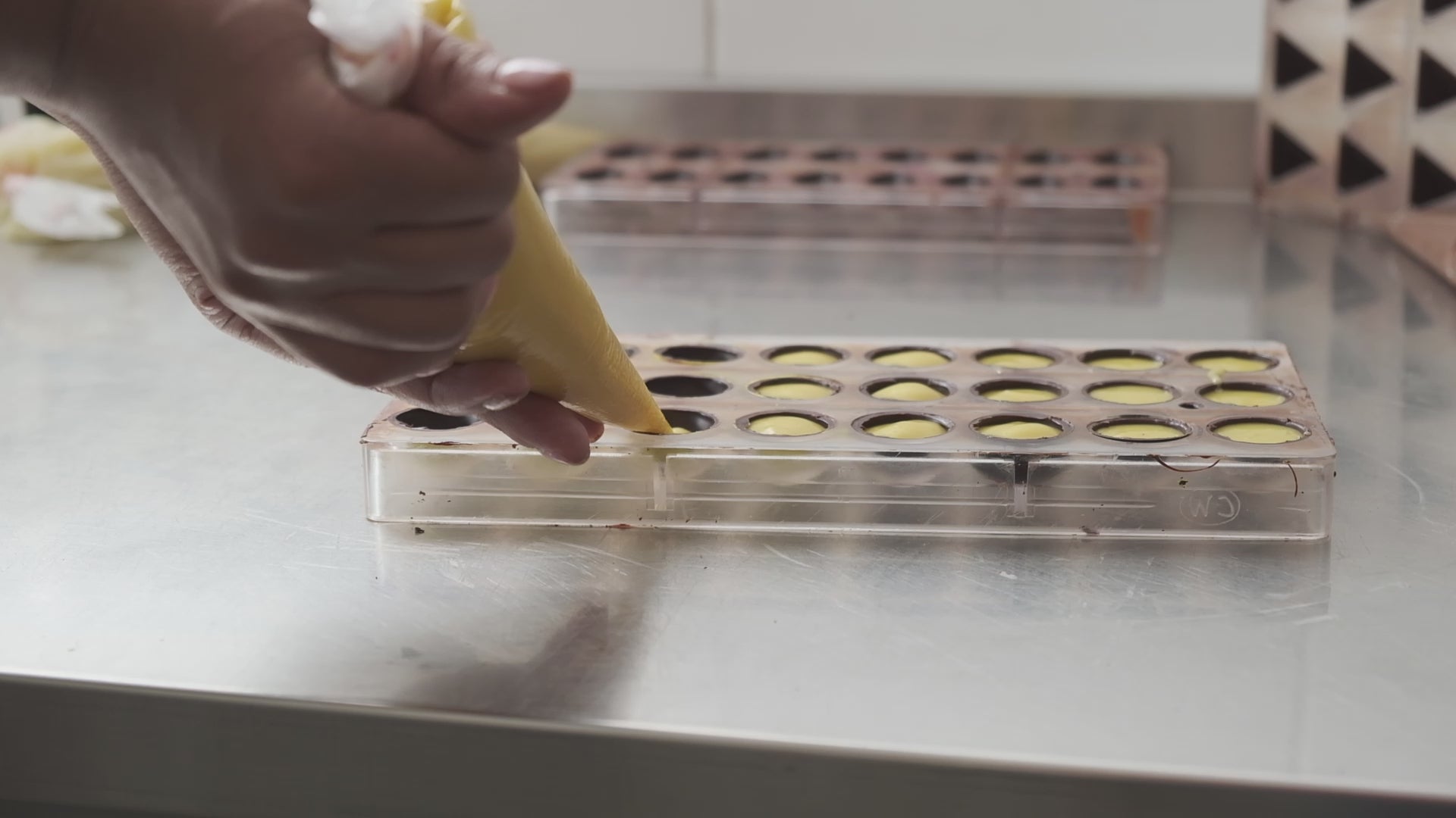 Load video: Blue Chocolatier piping filling into Chocolate mold